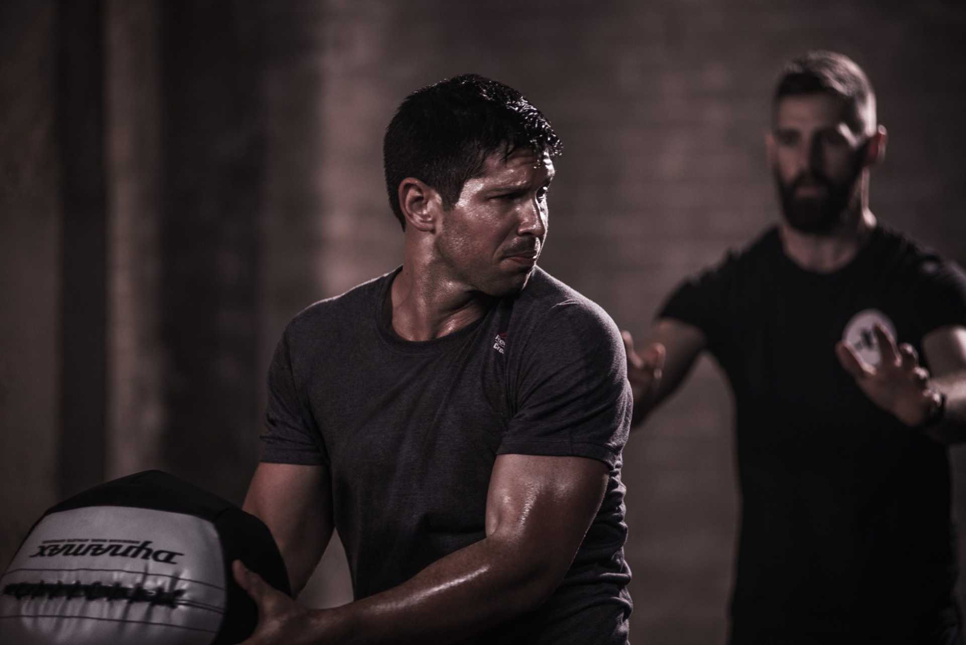 Man Working Out With 14lb Medicine Ball