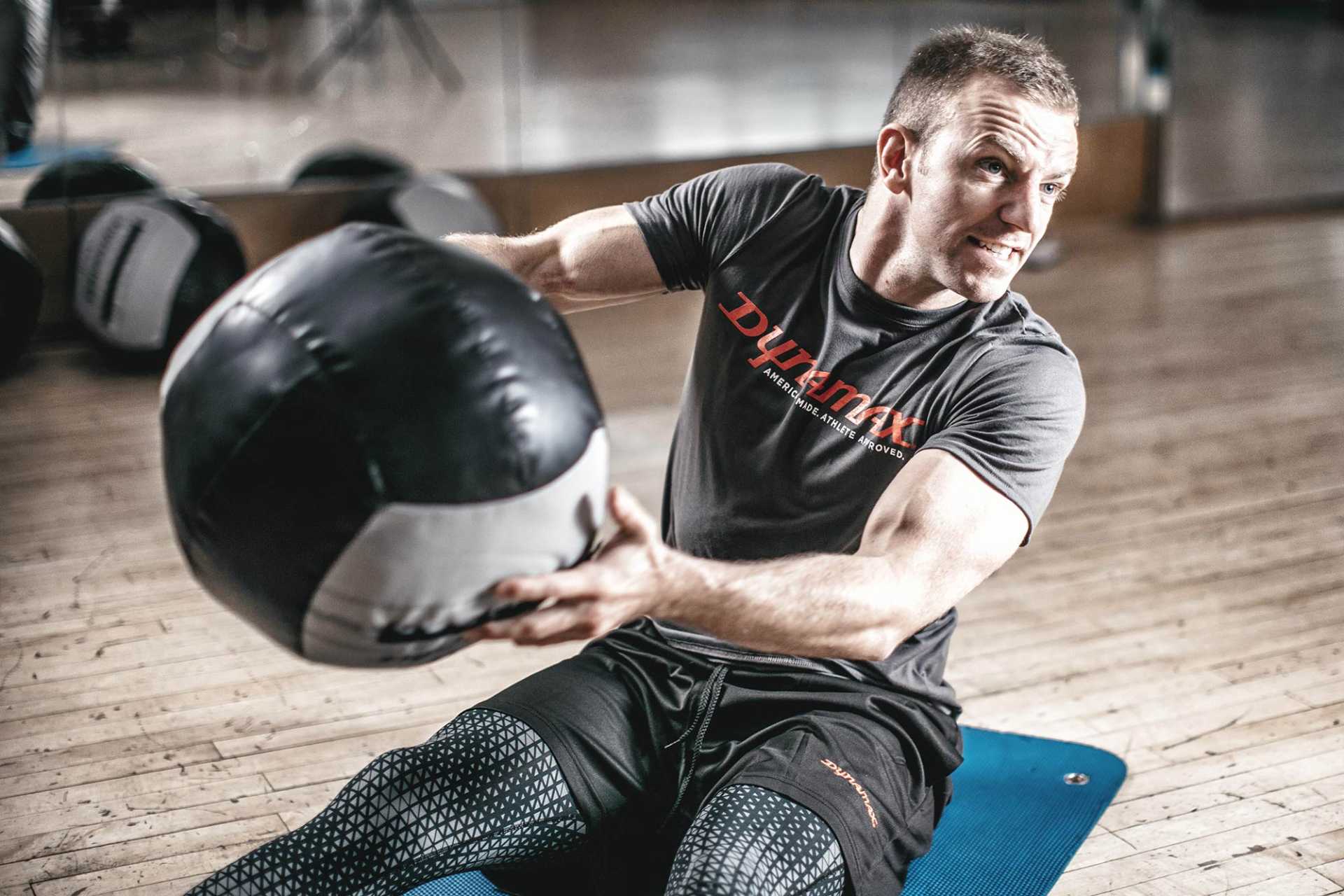 Man training with 30lb medicine ball