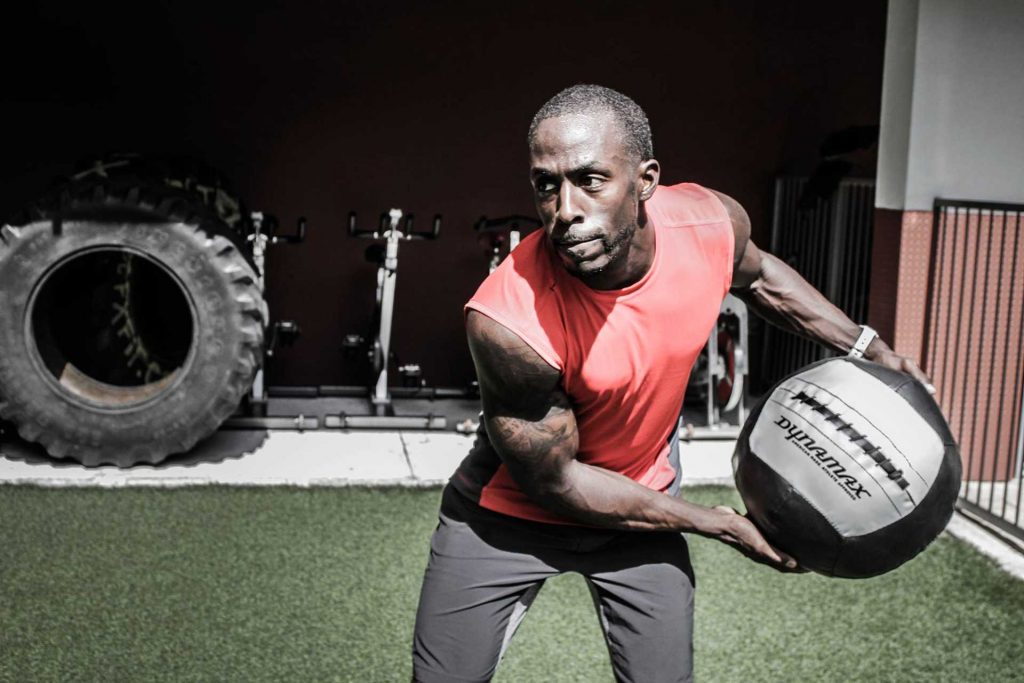 Man working out with 30lb Medicine Ball